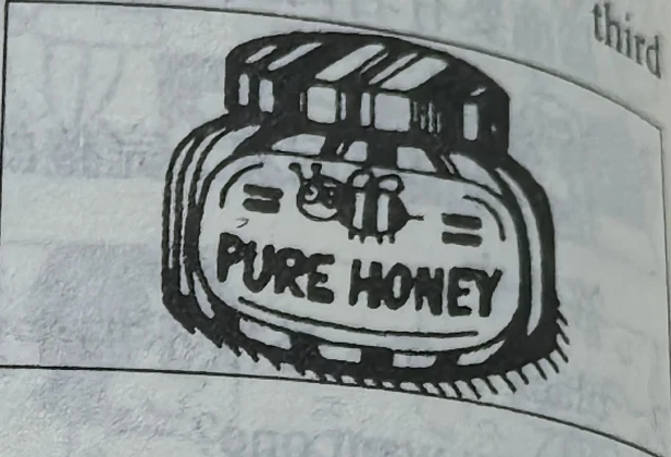 A jar labelled PURE HONEY.