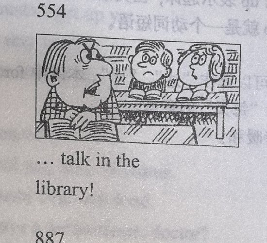 A librarian scolding a talking boy at the library desk; caption: '... talk in the library!'
